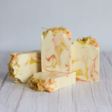 Load image into Gallery viewer, Marbled soap bars with natural fibers on a light wooden surface