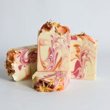Load image into Gallery viewer, Marbled soap bars with pink and orange swirls on a light gray background