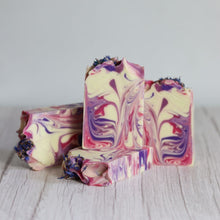 Load image into Gallery viewer, Colorful swirled soap bars on a light wooden surface