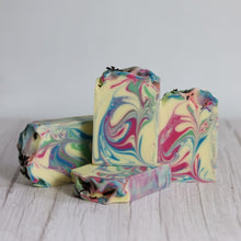 Load image into Gallery viewer, Three colorful swirled soap bars on a light wooden surface with a white background