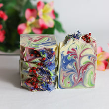 Load image into Gallery viewer, Colorful marbled soap bars with red and blue elements on a light background