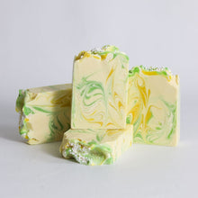 Load image into Gallery viewer, Three bars of soap with green and yellow swirled pattern on a light gray background