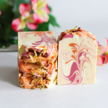 Load image into Gallery viewer, Marbled soap bar with floral elements on a light background
