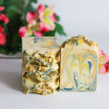 Load image into Gallery viewer, Two marbled soap bars with flowers in the background
